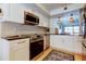 Modern kitchen with white cabinets, stainless steel appliances, and a stylish backsplash at 6290 Bahia Del Mar Cir # 5, St Petersburg, FL 33715