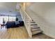 Open living area featuring a staircase, comfortable seating, and bright water views at 6290 Bahia Del Mar Cir # 5, St Petersburg, FL 33715