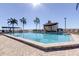 Large community pool surrounded by lounge chairs and palm trees at 6290 Bahia Del Mar Cir # 5, St Petersburg, FL 33715