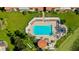 Aerial view of community pool surrounded by lounge chairs and lush landscaping at 6290 Bahia Del Mar Cir # 5, St Petersburg, FL 33715