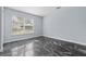 This light bedroom features a large window and elegant marble floor at 6489 Hazelwood Rd, Spring Hill, FL 34608
