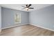 Bedroom featuring a ceiling fan, light gray walls, and a window with natural lighting at 6489 Hazelwood Rd, Spring Hill, FL 34608