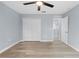 Bedroom featuring wood floors, light gray walls, a ceiling fan, and closet at 6489 Hazelwood Rd, Spring Hill, FL 34608