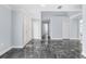 Bright foyer with marble floors, high ceilings, and white doors, leading into the home at 6489 Hazelwood Rd, Spring Hill, FL 34608