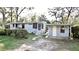 Charming home exterior with well-kept lawn and convenient storage shed at 7043 Lang St, Brooksville, FL 34601