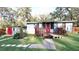 Charming home exterior with wooden deck and walkway, complemented by well-maintained landscaping at 7043 Lang St, Brooksville, FL 34601