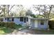 Cozy home with a screened porch, adjacent carport, and walkway to the front entrance at 7043 Lang St, Brooksville, FL 34601
