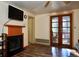 Living room with fireplace, wood floors, and glass patio doors at 7043 Lang St, Brooksville, FL 34601