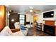 Comfortable living room with hardwood floors, fireplace, and ceiling fan at 7043 Lang St, Brooksville, FL 34601
