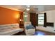 Bright living room featuring wood-look floors, ceiling fan, and ample seating at 7043 Lang St, Brooksville, FL 34601