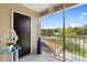 Enjoy this screened balcony with a peaceful lake view, chandelier, and additional decor at 7210 N Manhattan # 1822, Tampa, FL 33614