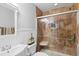 Bright bathroom featuring tiled shower with glass door and integrated shelving at 7210 N Manhattan # 1822, Tampa, FL 33614