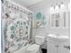 Bright bathroom with ornate curtain, anchor decor, and ample lighting at 7210 N Manhattan # 1822, Tampa, FL 33614