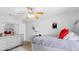 Bedroom featuring a ceiling fan, large mirror, dresser, and a bed with pillows at 7210 N Manhattan # 1822, Tampa, FL 33614
