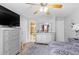 Bedroom with a view to the ensuite bathroom, ceiling fan, and large dresser at 7210 N Manhattan # 1822, Tampa, FL 33614