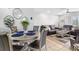 This dining area is staged with a stylish table set and leads into the living room at 7210 N Manhattan # 1822, Tampa, FL 33614