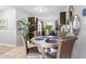 Bright dining area near the kitchen featuring a round table, cushioned chairs, and neutral decor at 7210 N Manhattan # 1822, Tampa, FL 33614