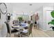Cozy dining area with stylish chairs, mirrors, and views of the living room and sliding glass doors at 7210 N Manhattan # 1822, Tampa, FL 33614