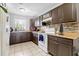 The functional kitchen offers tiled floors, white appliances, and practical workspace at 7210 N Manhattan # 1822, Tampa, FL 33614