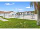 Community pool surrounded by lush green lawn and mature landscaping at 7210 N Manhattan # 1822, Tampa, FL 33614