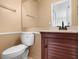 Cozy bathroom features a wood vanity, toilet, and large mirror at 8460 Calais N # 8406, Pinellas Park, FL 33781