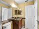 Bathroom features a stylish vanity, modern fixtures, and convenient door access, creating a comfortable space at 8460 Calais N # 8406, Pinellas Park, FL 33781