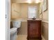 Cozy bathroom features a wood vanity, toilet, and large mirror at 8460 Calais N # 8406, Pinellas Park, FL 33781