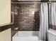 Bathroom showcases modern tiled shower, white fixtures, and accessibility features, promoting safety and style at 8460 Calais N # 8406, Pinellas Park, FL 33781