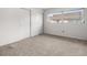 Bedroom boasting neutral carpeting, window views, and closet spaces for peaceful living at 8460 Calais N # 8406, Pinellas Park, FL 33781