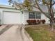 Charming single-story home with a white garage door and a driveway at 8460 Calais N # 8406, Pinellas Park, FL 33781