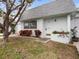 Charming single-story home with a white front door and a beautifully landscaped front yard at 8460 Calais N # 8406, Pinellas Park, FL 33781