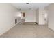 Inviting carpeted living room with tile flooring transitions seamlessly into the kitchen and other rooms, offering a bright and open layout at 8460 Calais N # 8406, Pinellas Park, FL 33781
