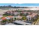 Scenic aerial view of beachfront condos with a pool, landscaping, and beach access to the bay at 855 Bayway Blvd # 105, Clearwater, FL 33767