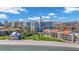 Condo buildings next to white sand beach featuring grassy area and blue house at 855 Bayway Blvd # 105, Clearwater, FL 33767