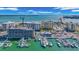 Captivating aerial view of a marina with numerous boats docked, near modern condominium buildings at 855 Bayway Blvd # 105, Clearwater, FL 33767