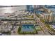 Aerial view of tennis courts, a beach, parking, and roadways near the condo complex at 855 Bayway Blvd # 105, Clearwater, FL 33767