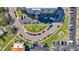 Aerial view of condo building with circular driveway and ample parking, surrounded by green spaces at 855 Bayway Blvd # 105, Clearwater, FL 33767