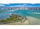 Panoramic aerial showcasing a bridge connecting a lush island and city skyline over tranquil waters at 855 Bayway Blvd # 105, Clearwater, FL 33767