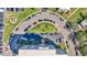 Aerial view of condo building, circular driveway, and parking areas, with tropical landscaping at 855 Bayway Blvd # 105, Clearwater, FL 33767