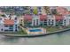Aerial view of waterfront condos with a swimming pool and lush landscaping by the bay at 855 Bayway Blvd # 105, Clearwater, FL 33767