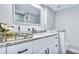 Bathroom vanity featuring white marble countertop and drawers with black pulls, exuding modern elegance at 855 Bayway Blvd # 105, Clearwater, FL 33767