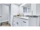 Updated bathroom featuring a white vanity, marble countertop, and modern fixtures at 855 Bayway Blvd # 105, Clearwater, FL 33767