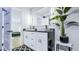 Modern bathroom featuring a double sink vanity, sleek fixtures, and illuminated mirror at 855 Bayway Blvd # 105, Clearwater, FL 33767