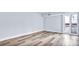 Bedroom with balcony, lots of natural light, and wood-look flooring at 855 Bayway Blvd # 105, Clearwater, FL 33767