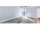 Bedroom featuring wood-look flooring, a balcony and light colored walls at 855 Bayway Blvd # 105, Clearwater, FL 33767