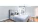 Light and airy bedroom with balcony access and wood-look flooring at 855 Bayway Blvd # 105, Clearwater, FL 33767