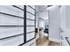 Walk-in closet with glass-door cabinets and built-in shelving leading to living area at 855 Bayway Blvd # 105, Clearwater, FL 33767