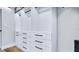 Walk-in closet with custom built-in shelving and drawers offers organized storage at 855 Bayway Blvd # 105, Clearwater, FL 33767