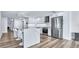Modern kitchen featuring stainless steel appliances, white cabinets, and a large center island at 855 Bayway Blvd # 105, Clearwater, FL 33767