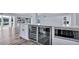 Kitchen featuring a wine cooler, microwave and ample counter space at 855 Bayway Blvd # 105, Clearwater, FL 33767
